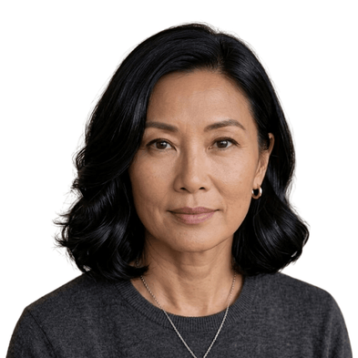 Woman with black hair wearing a gray sweater on a white background