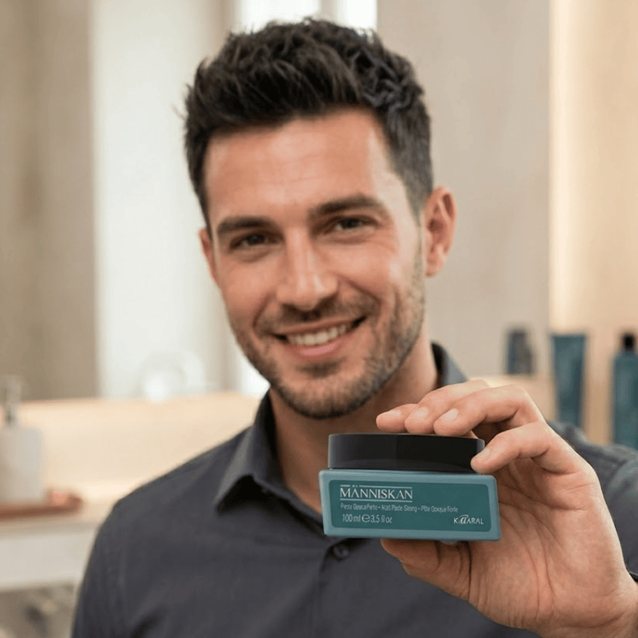 Brown Haired Male Holding Manniskan Matte Paste from Kaaral